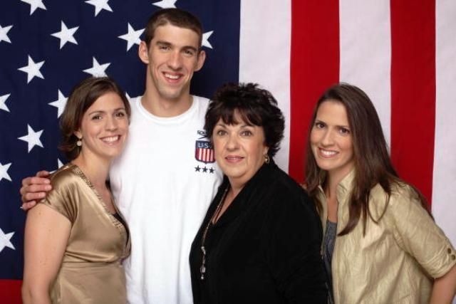 Michael Phelps with his mother and two sisters